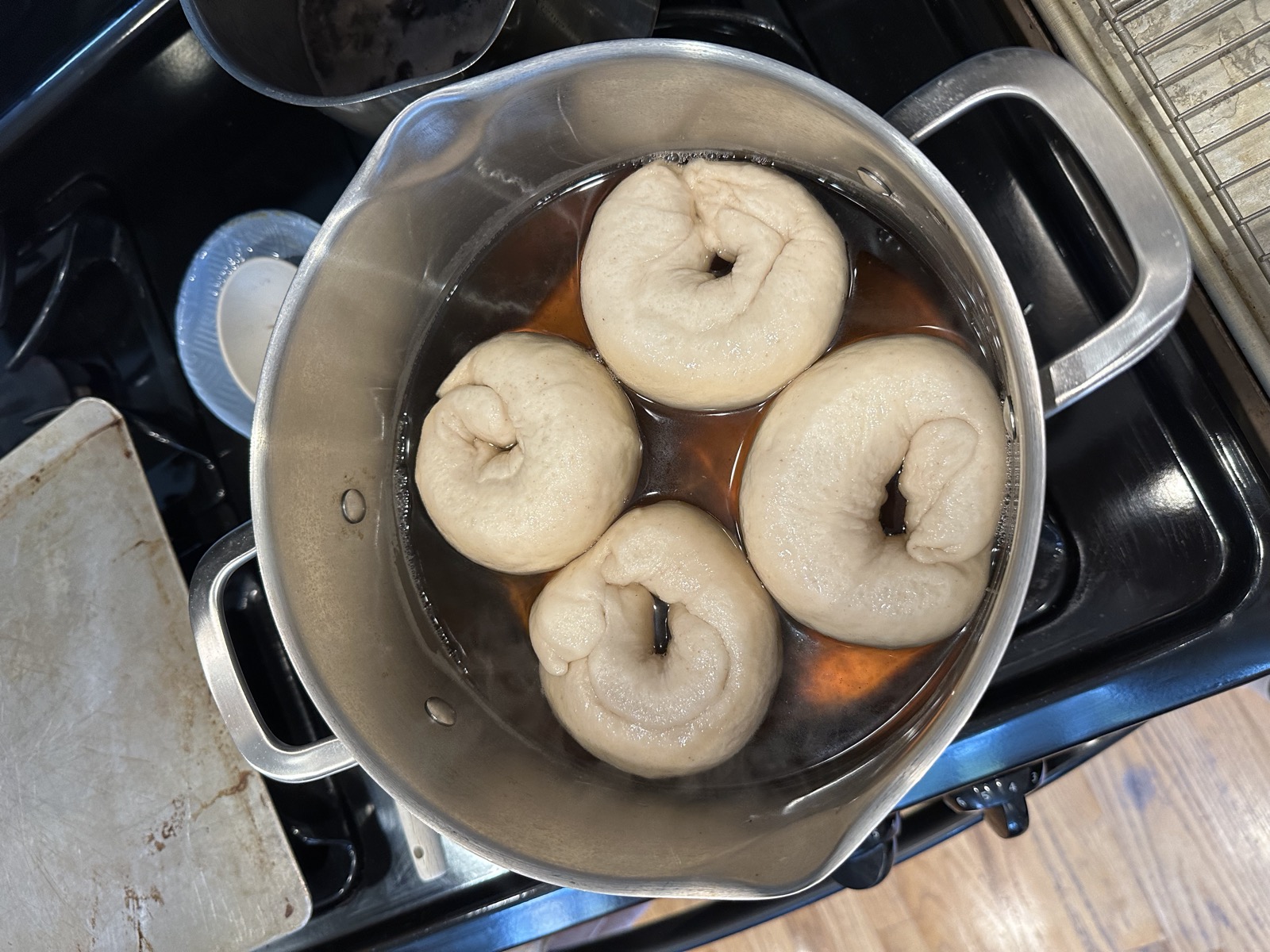 Bagel dough boiling in a malt water bath