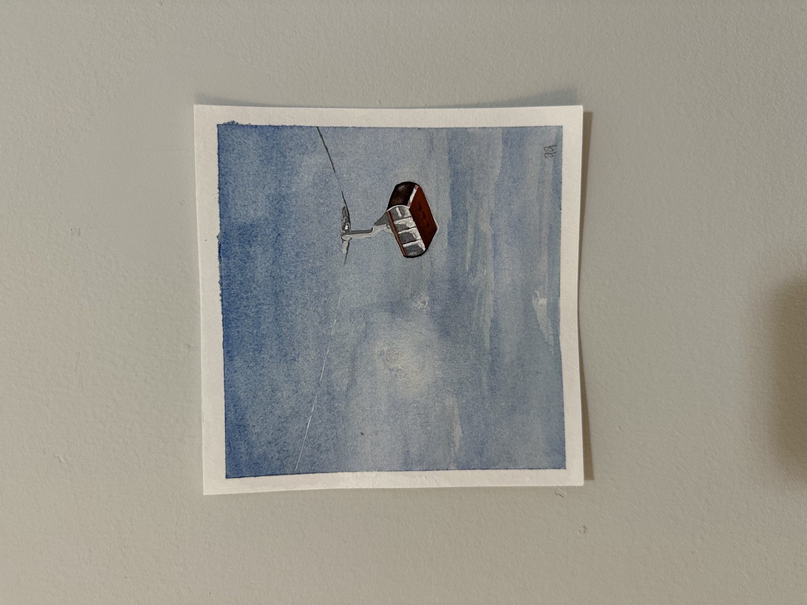 Watercolor painting of a ski gondola against a cloudy sky